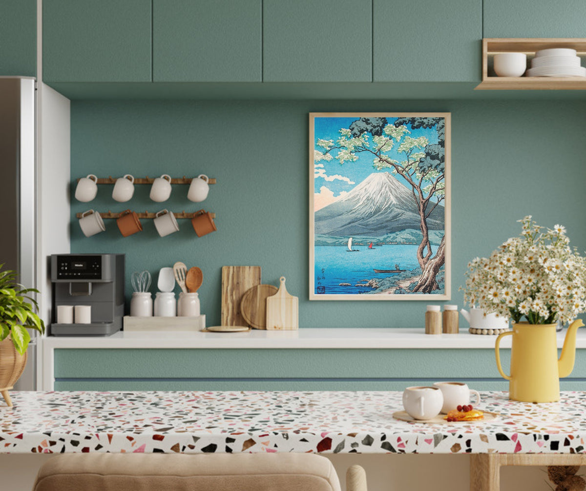 Lyrea art print in a light wood frame on an open kitchen shelf with a teal cabinet wall