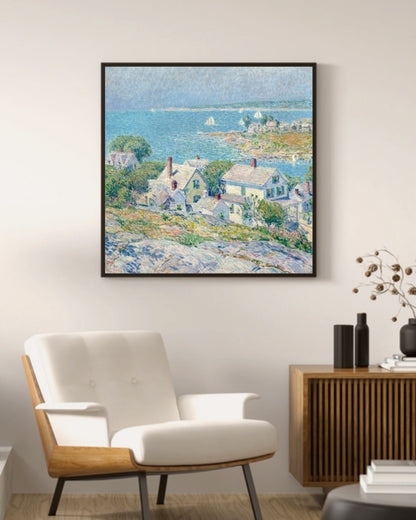 New England Headlands art print in a black square frame above a mid-century armchair and wood sideboard