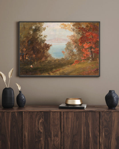 Woodland Scene in Autumn art print in a black landscape frame above a walnut sideboard