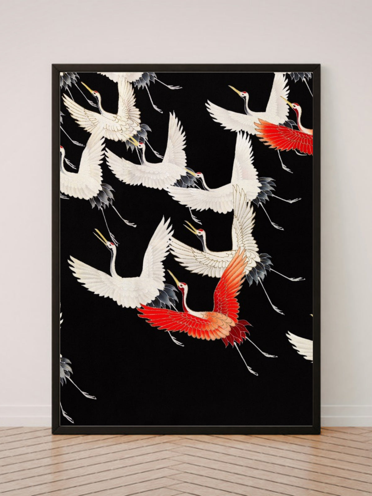 Furisode with a Myriad of Flying Cranes art print in a black frame, leaning against a white wall on a wood floor