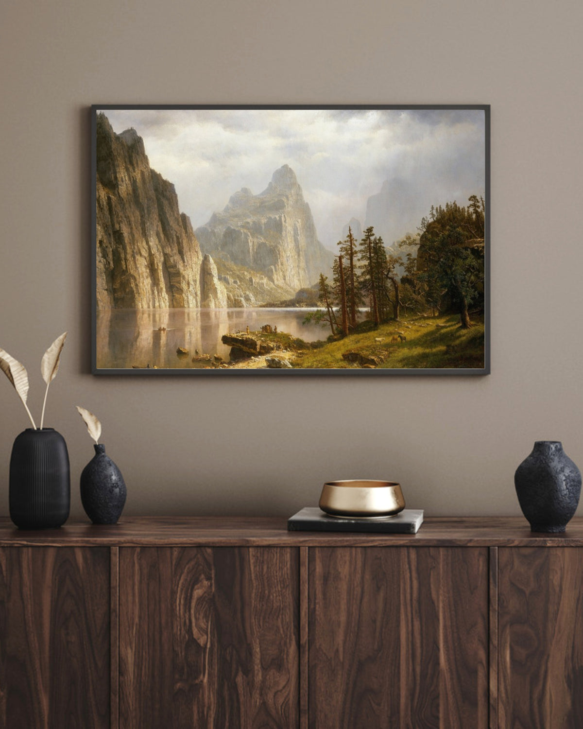 Merced River art print in a black landscape frame above a walnut sideboard