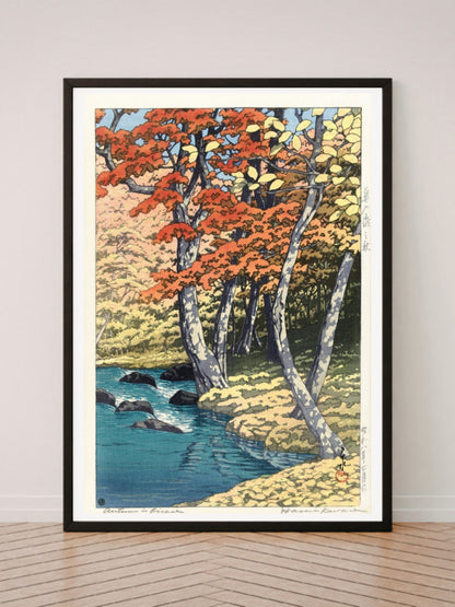 Herfst in Oirase art print in a black frame, leaning against a white wall on a wood floor