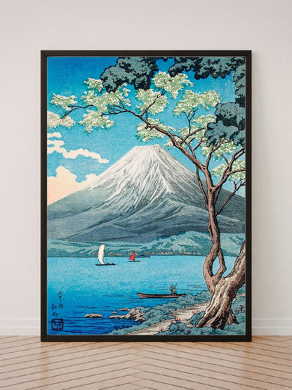 Mount Fuji from Lake Yamanaka art print in a black frame, leaning against a white wall on a wood floor