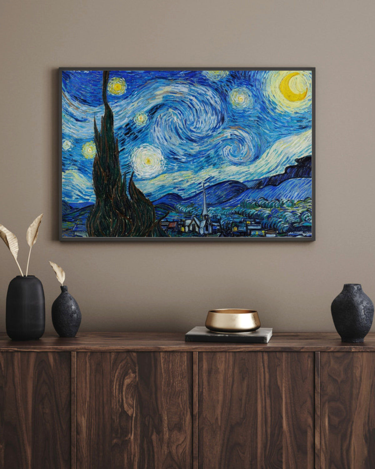 The Starry Night art print in a black landscape frame above a walnut sideboard
