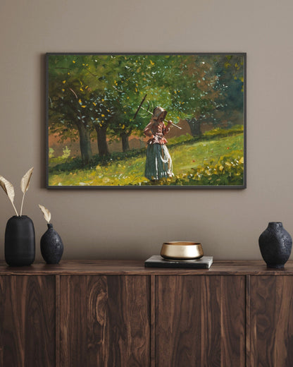 Girl with Hay Rake art print in a black landscape frame above a walnut sideboard