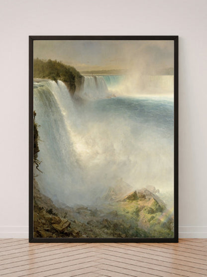 Niagara Falls art print in a black frame, leaning against a white wall on a wood floor